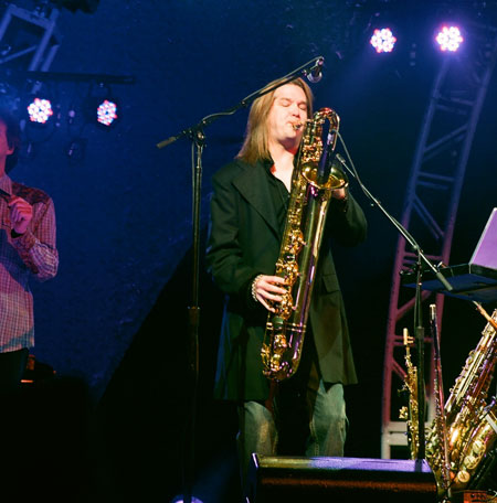 Kenny Loggins in concert with band members wearing Old Frontier Frock Coat