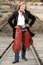woman wearing frock coat with chaps