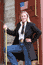 Woman wearing frock coat standing on a train